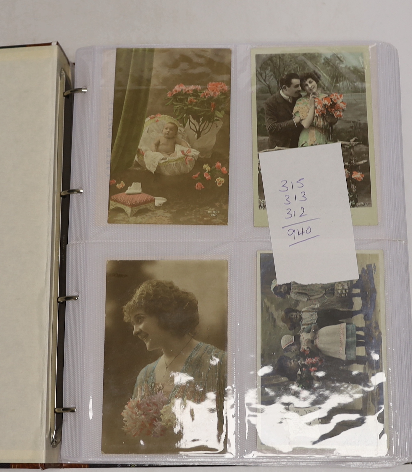 A large quantity of postcards, 940 total in three albums, all French, early 20th century